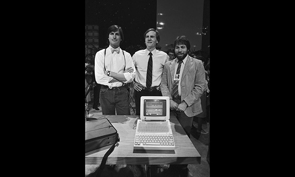Steve Jobs, Apple CEO John Sculley, and Apple cofounder Steve Wozniak unveil a new computer in 1984.