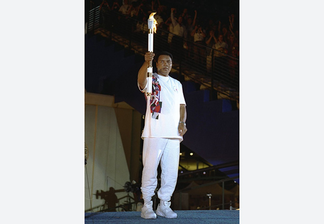 Muhammad Ali holds the torch before lighting the Olympic Flame during the opening ceremony of the Centennial Olympic Games in Atlanta on July 19, 1996.